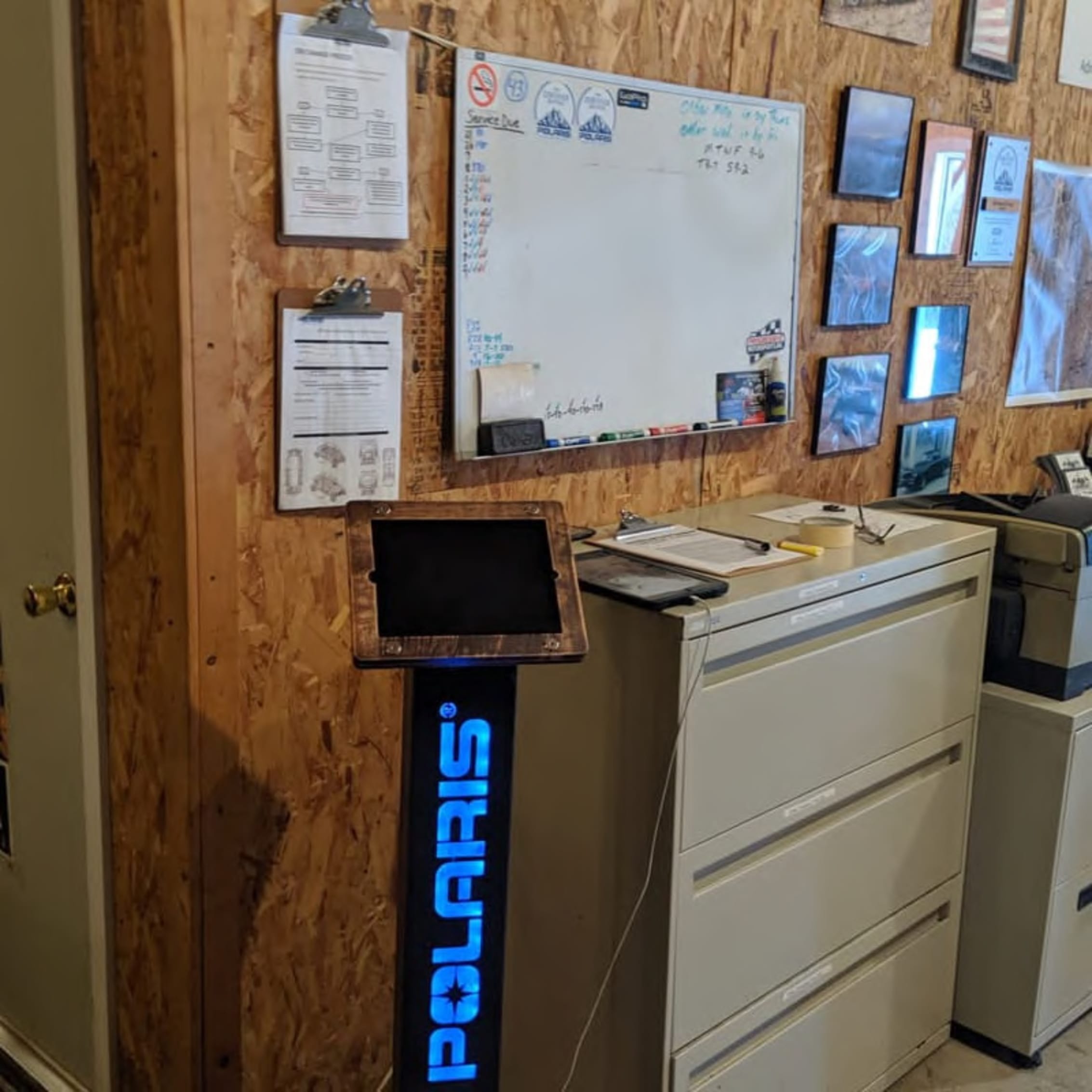 Office setup with Polaris branding, whiteboard, and adventure planning materials on the wall.