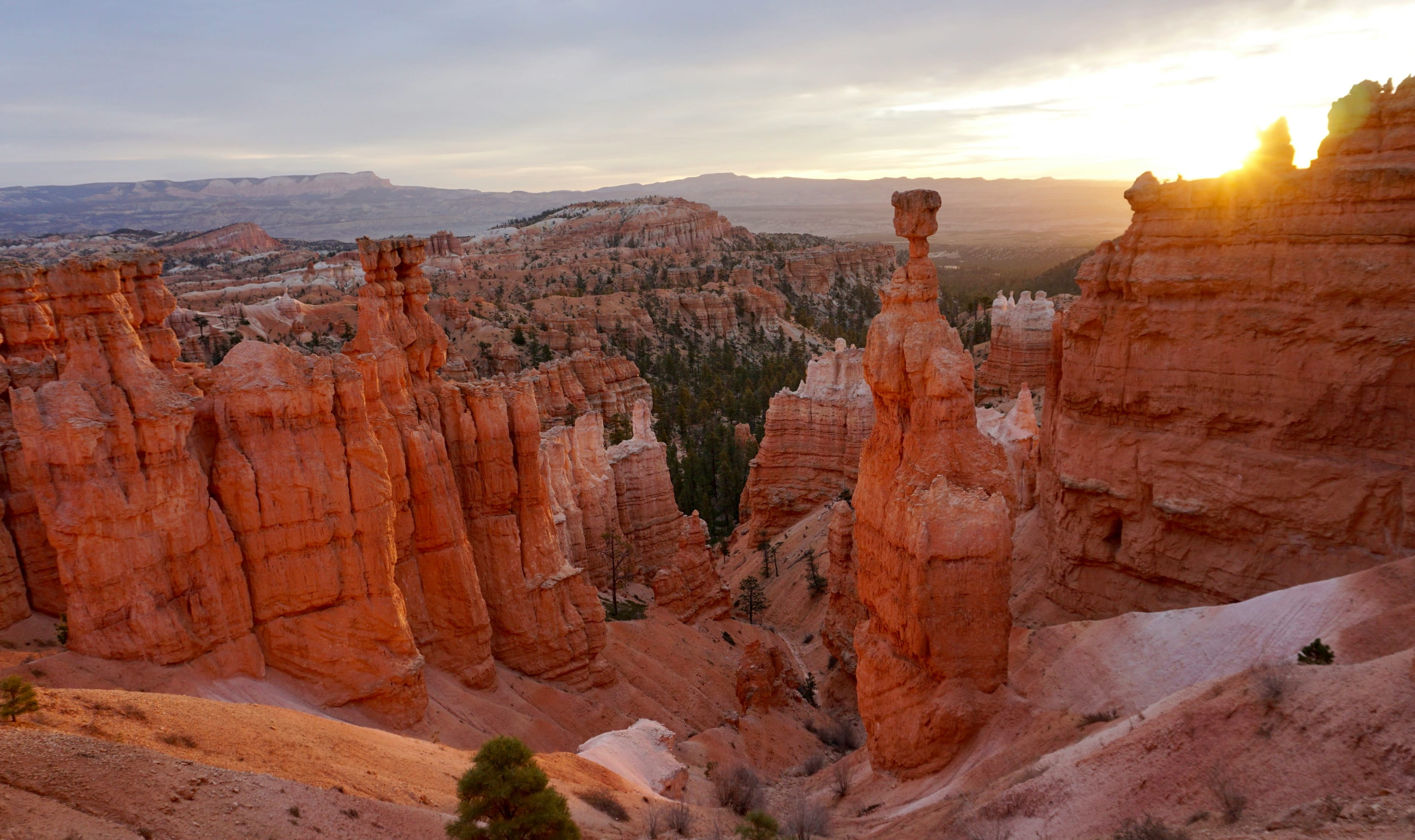 Sunrise over the orange hoodoos of Bryce Canyon National Park, highlighting adventure travel destinations.