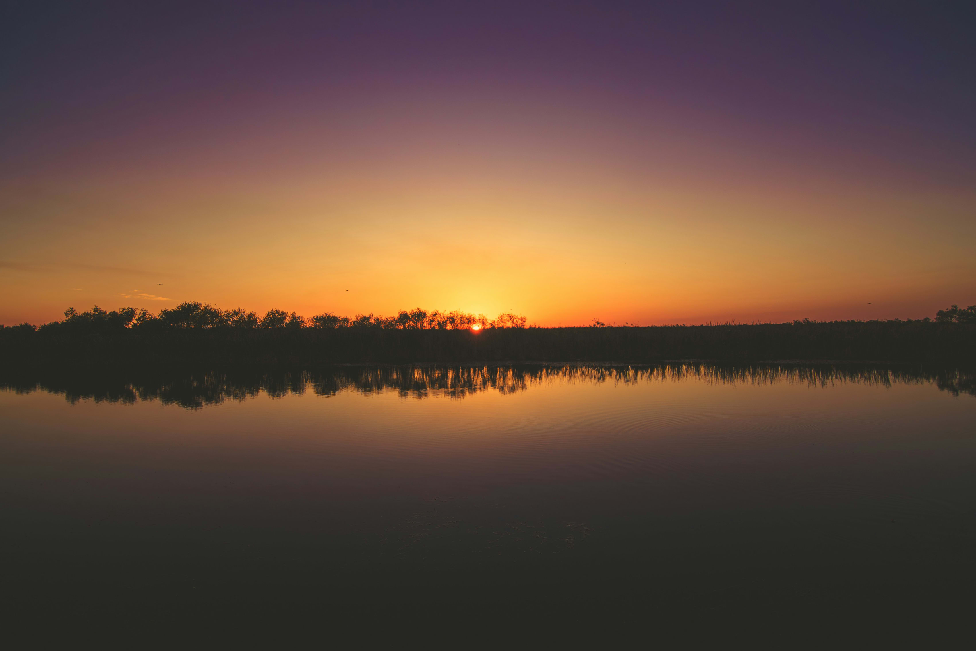 Sunset at Everglades National Park with colorful sky reflecting on calm water.
