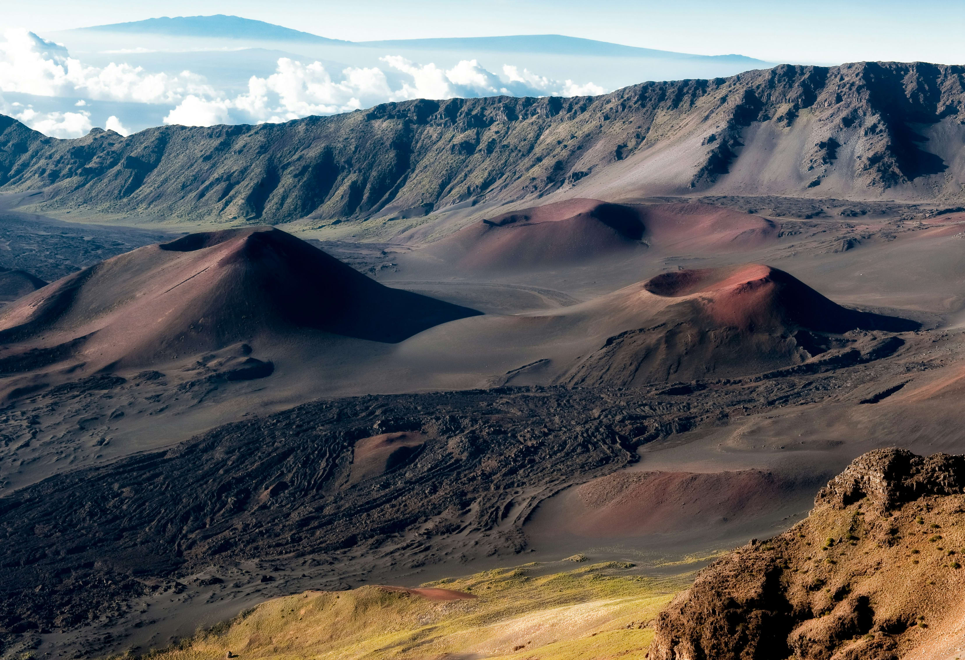 Aerial view of Haleakala National Park showcasing the volcanic landscape with craters and diverse colors.