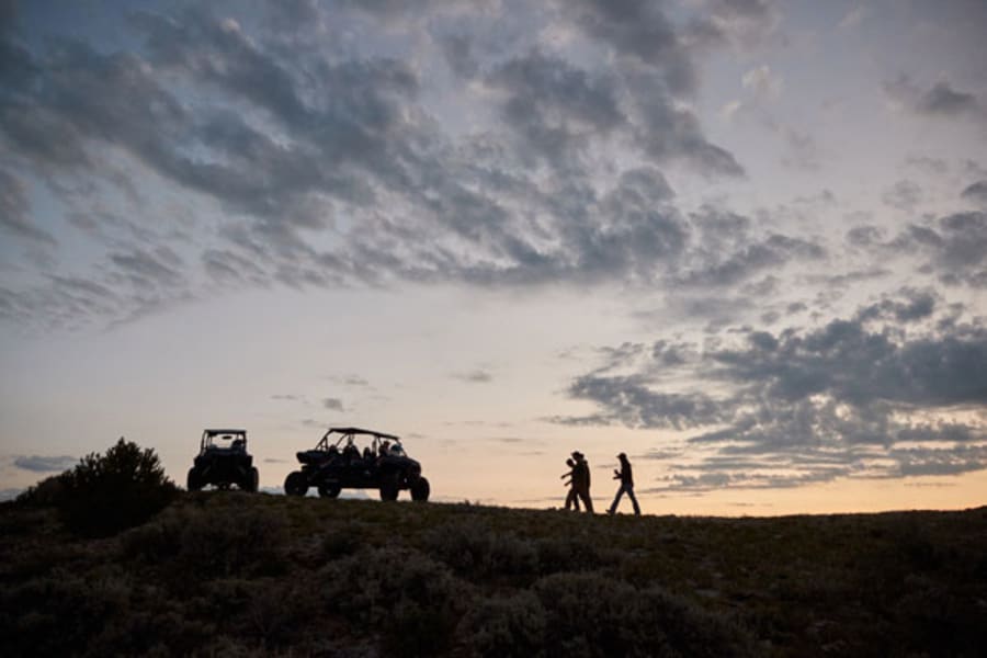 Sunset silhouette of ORV riders