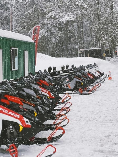 Lineup of Polaris snowmobiles outside 201 PowerSports The Forks