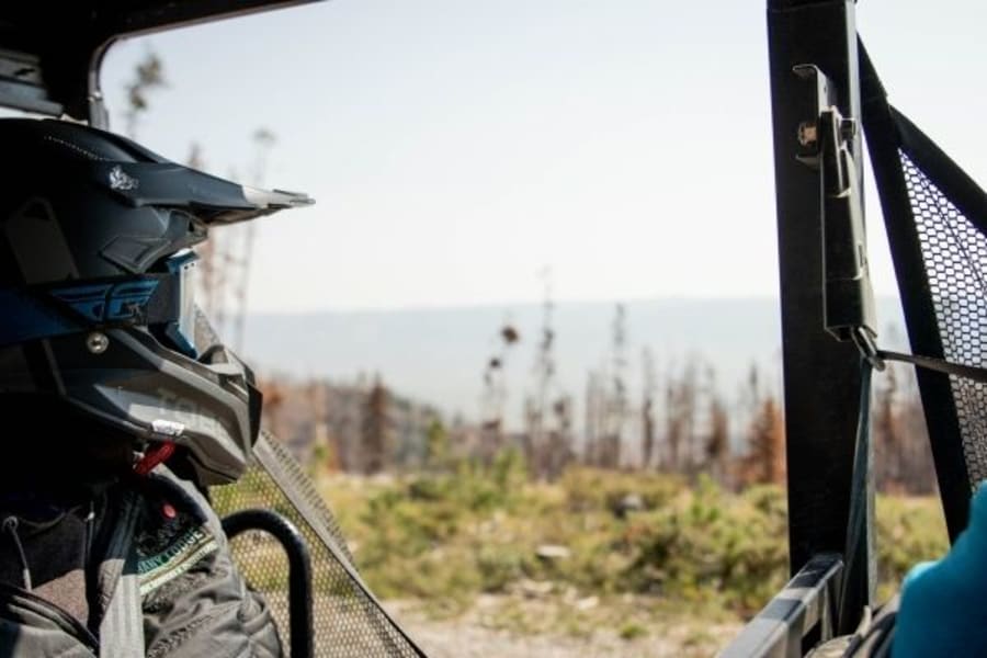 Person in helmet looking out of a Polaris ORV