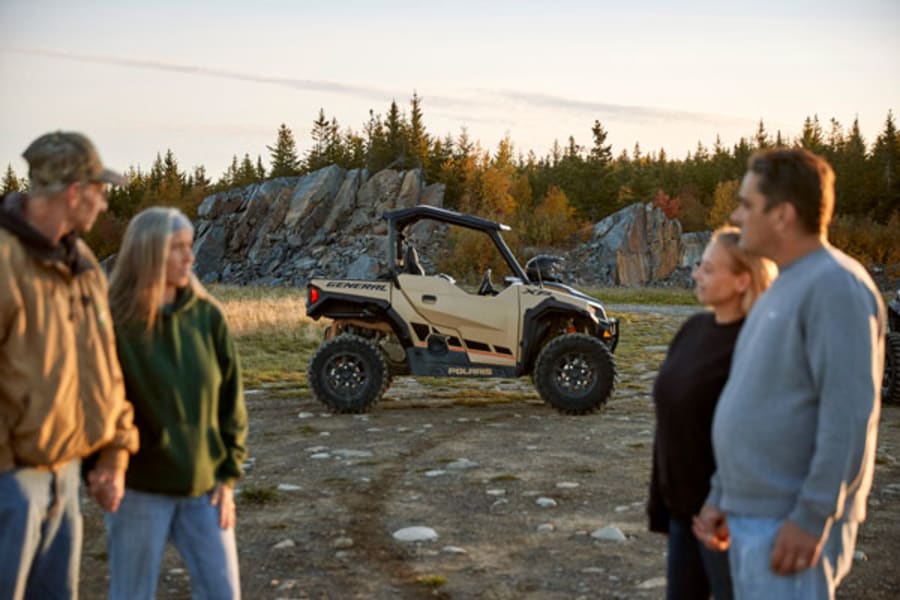 Two couples standing by Polaris side by side