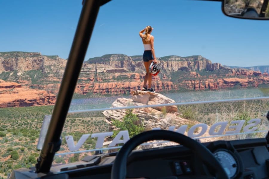 Woman standing on rock by Polaris side by side.