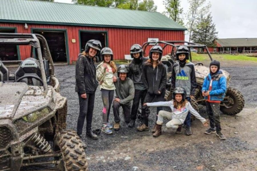 Family standing in front of a Polaris side by side