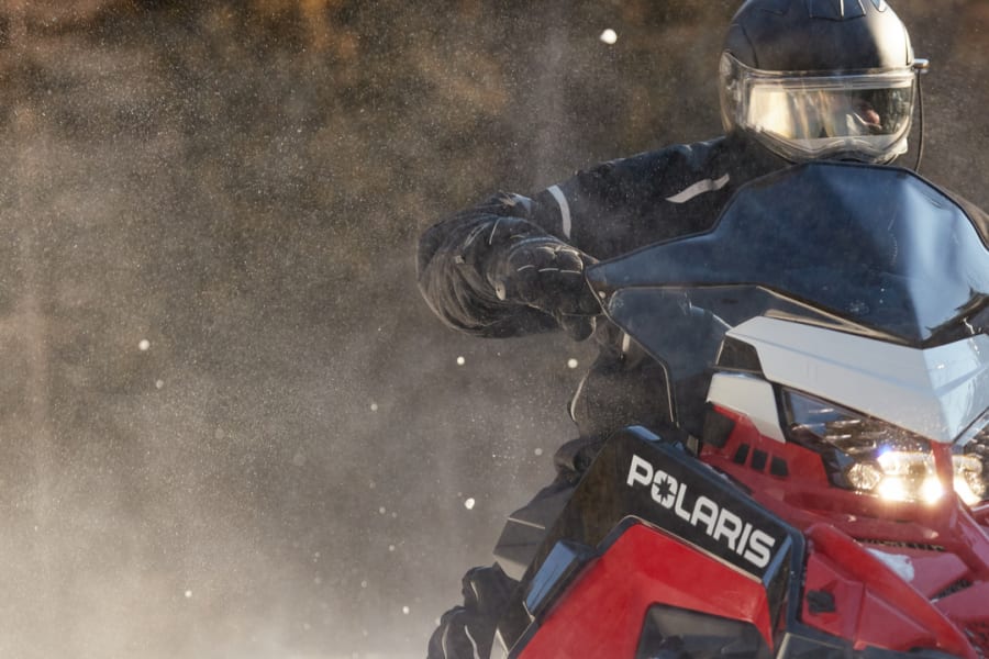Polaris snowmobile and rider
