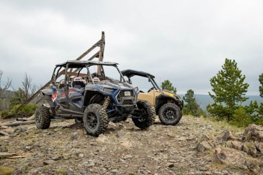 Two Polaris side by sides near abandoned gold mine