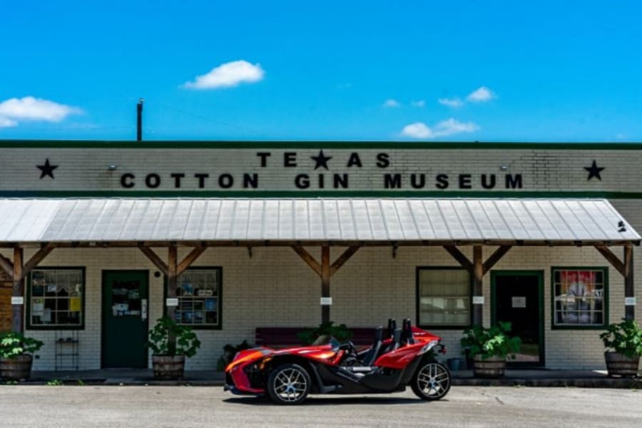 Polaris Slingshot in front of Texas Cotton Gin Museum
