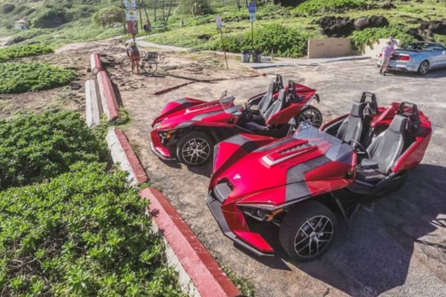 Two red Polaris Slingshots