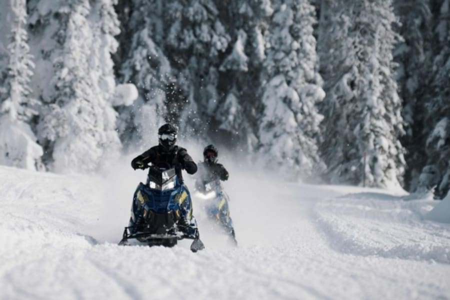Two Polaris snowmobilers in Maine