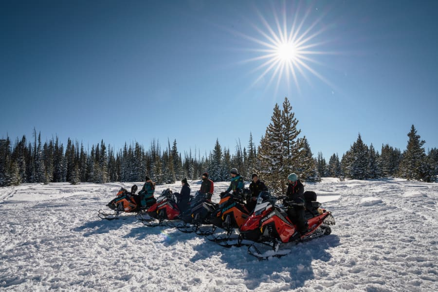 Lineup of Polaris snowmobile riders