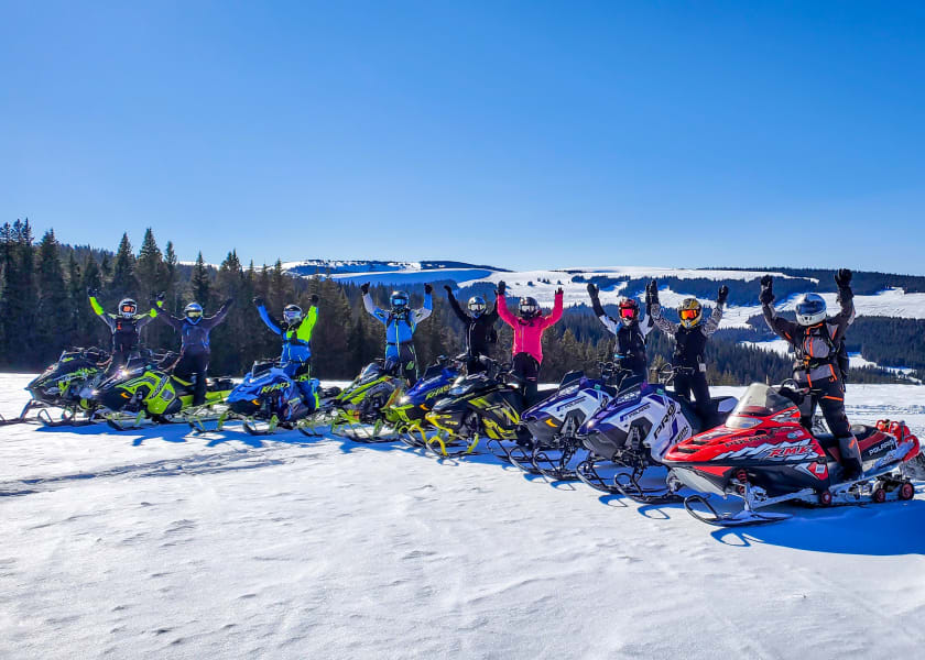 Happy snowmobilers atop a Wyoming mountain