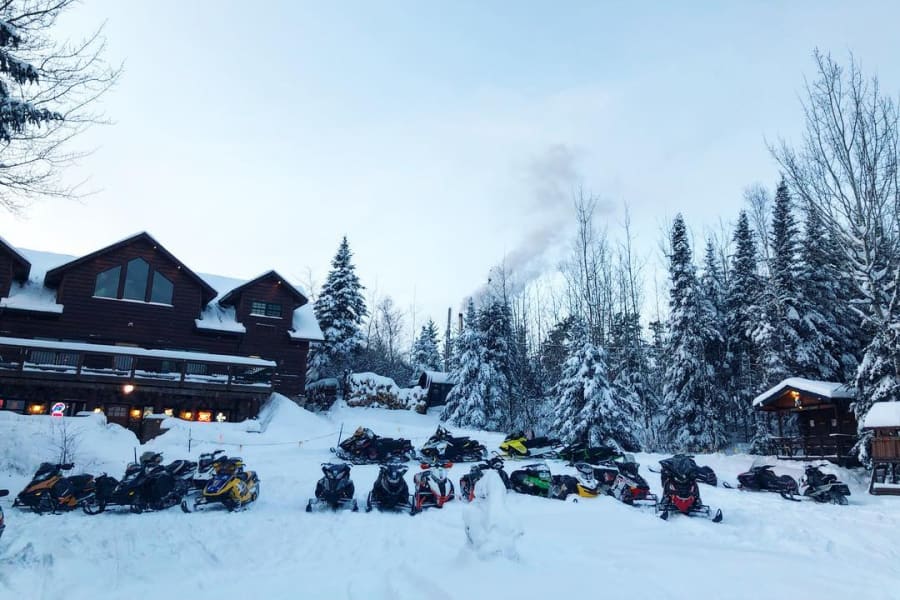 snowmobiles parked outside Hungry Jack Lodge in Grand Marais, Minnesota.