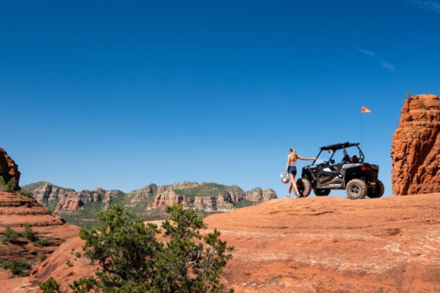 Woman standing next to Polaris side by side in Sedona.