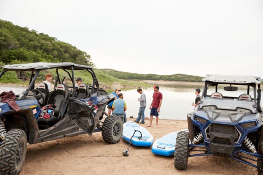 Paddleboarding and Polaris side by sides