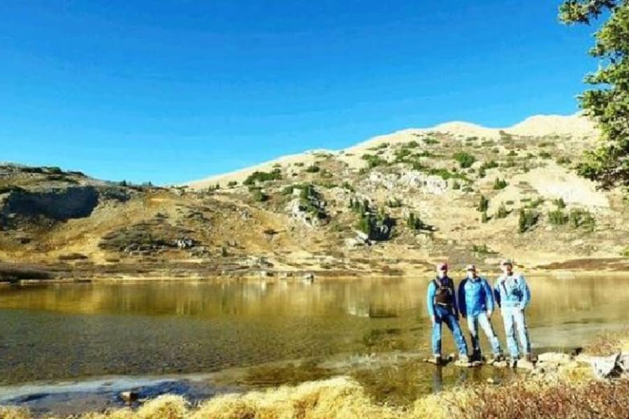 Three men standing by lake in Colorado
