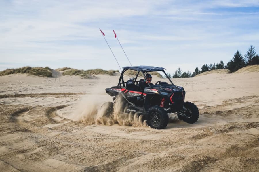 Polaris RZR kicking up beach sand
