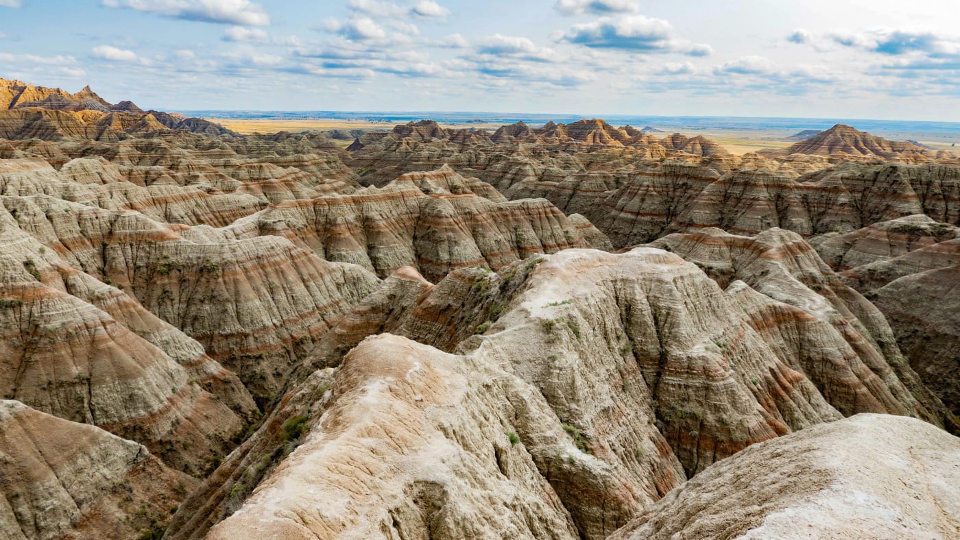 Scenic view of the layered rock formations and vast skies at the Badlands National Park