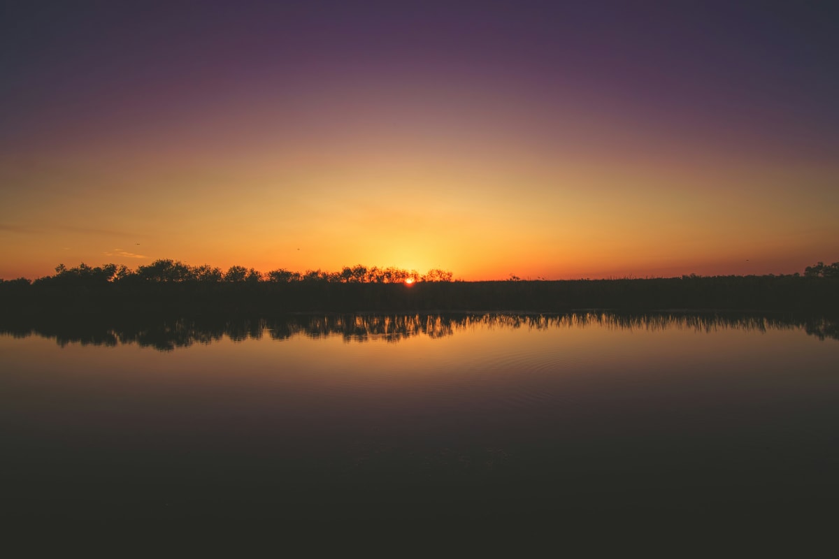 Sunset at Everglades National Park with colorful sky reflecting on calm water.