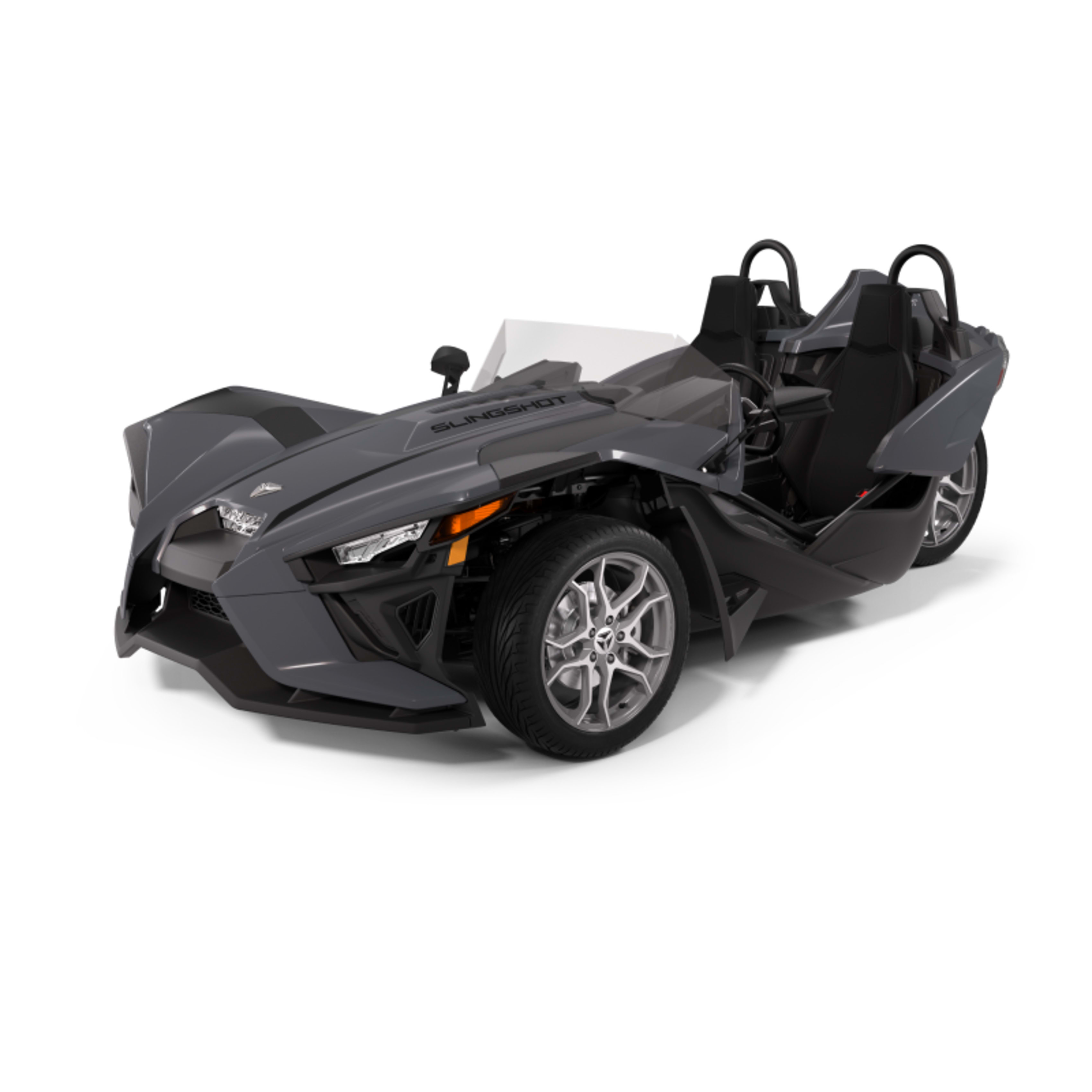 Charcoal gray Polaris Slingshot three-wheeled vehicle, showcasing its distinctive, angular design and open cockpit, isolated on a white background.