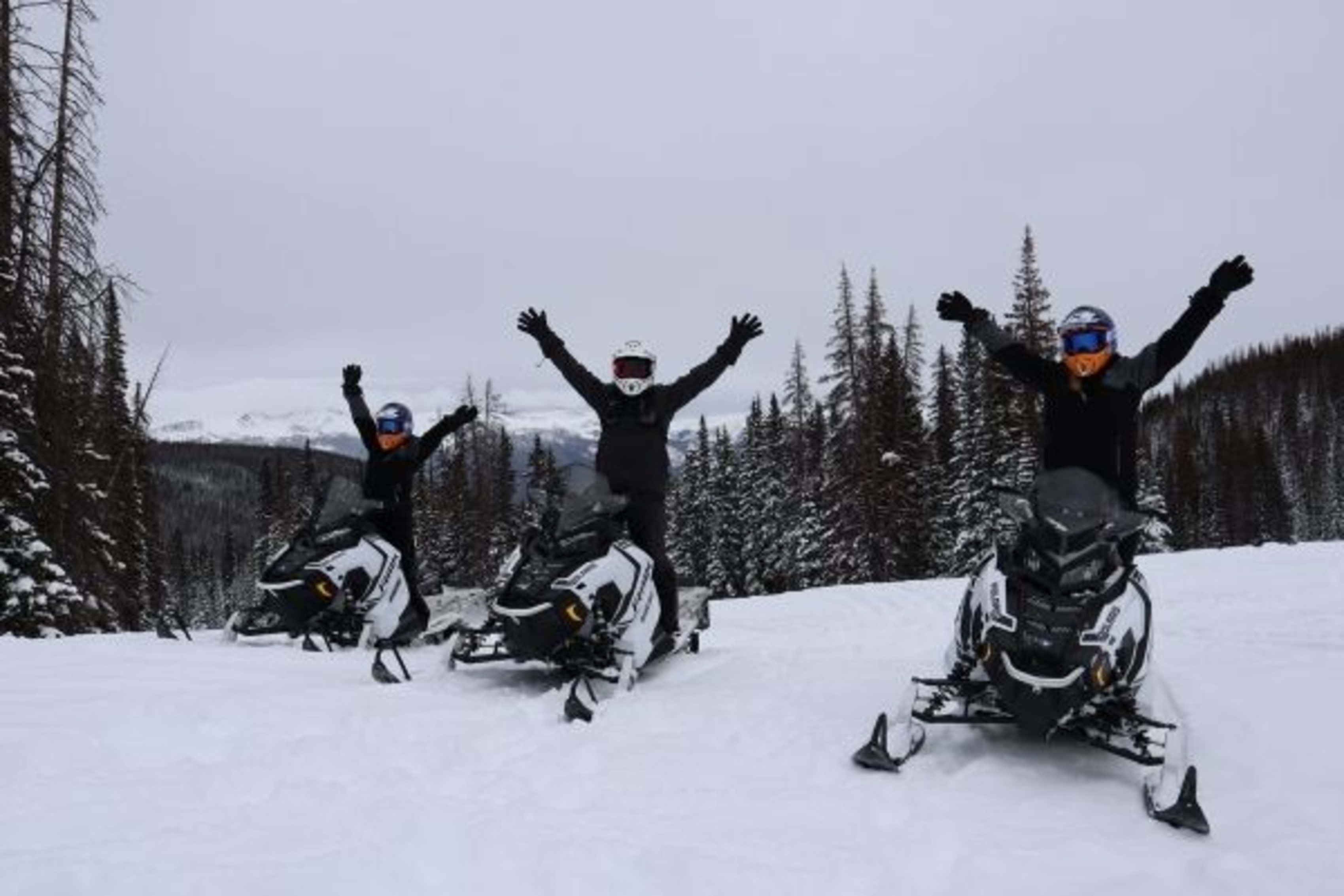 Three Polaris snowmobile riders in Colorado