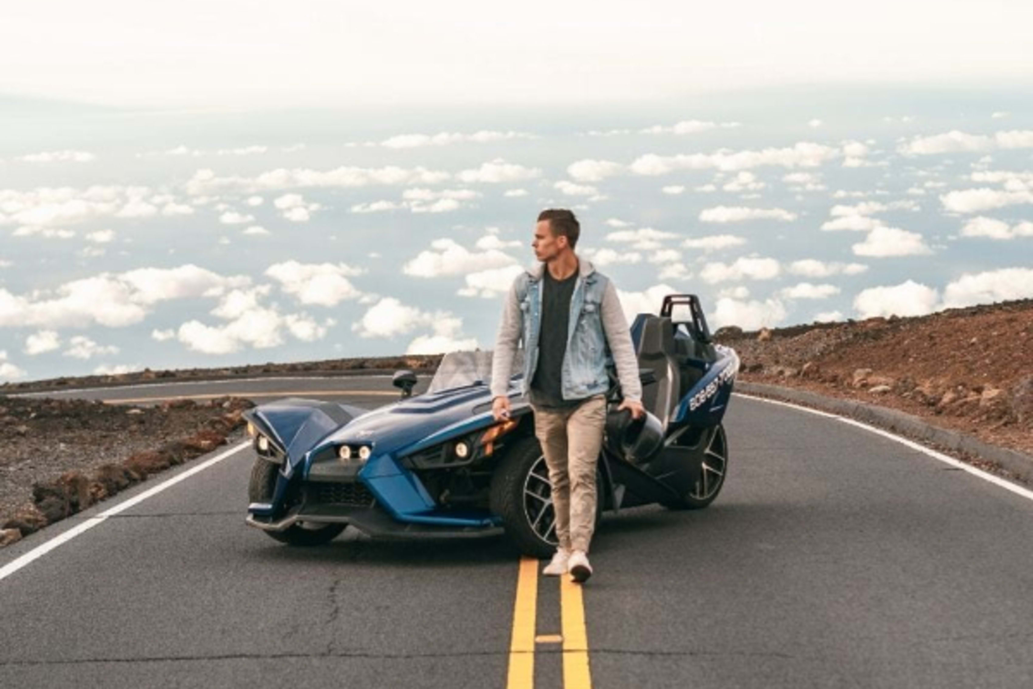 Man walking in front of Polaris Slingshot