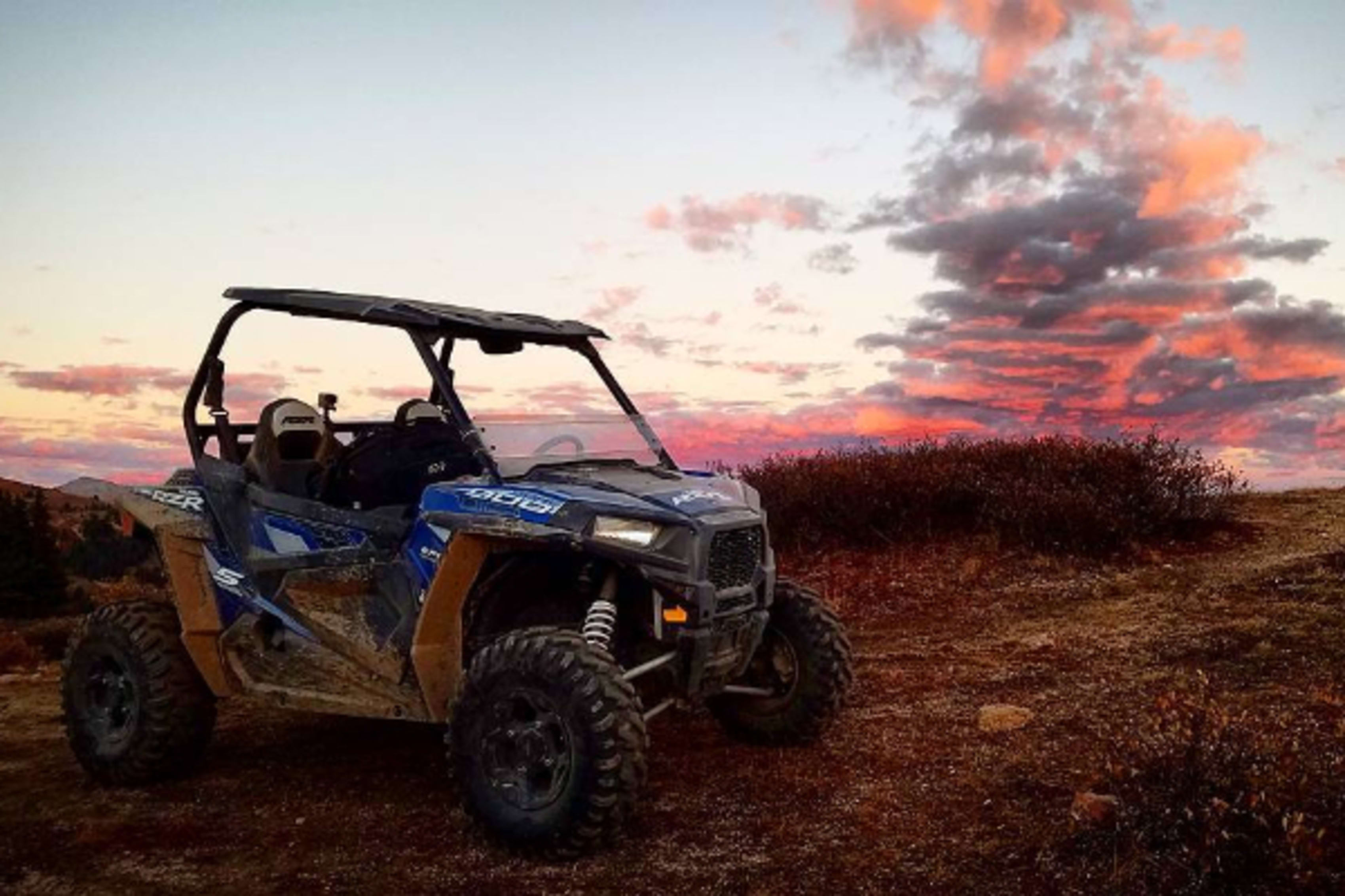 Two-seat Polaris RZR in Colorado with sunset