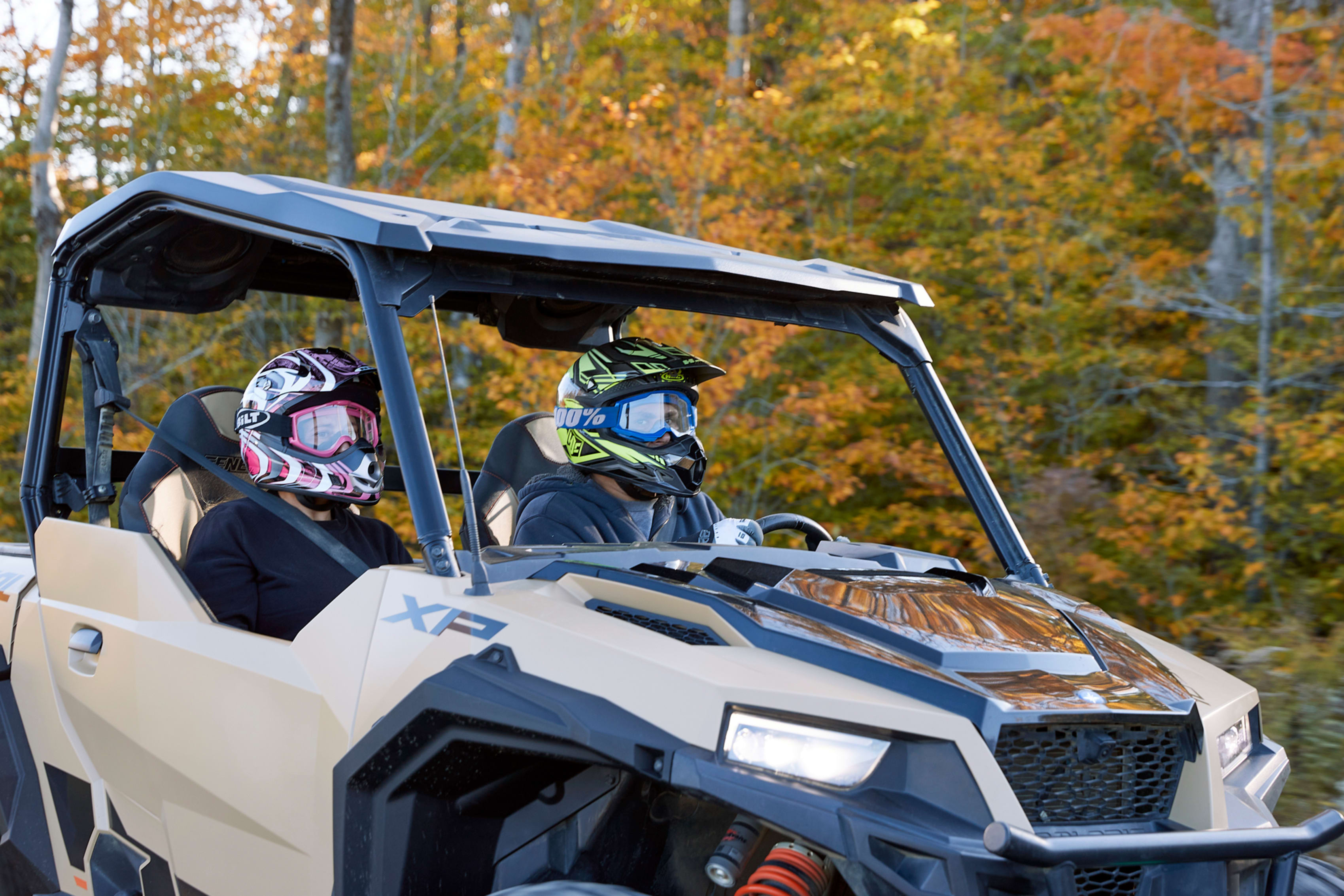 Two people in Polaris General ORV