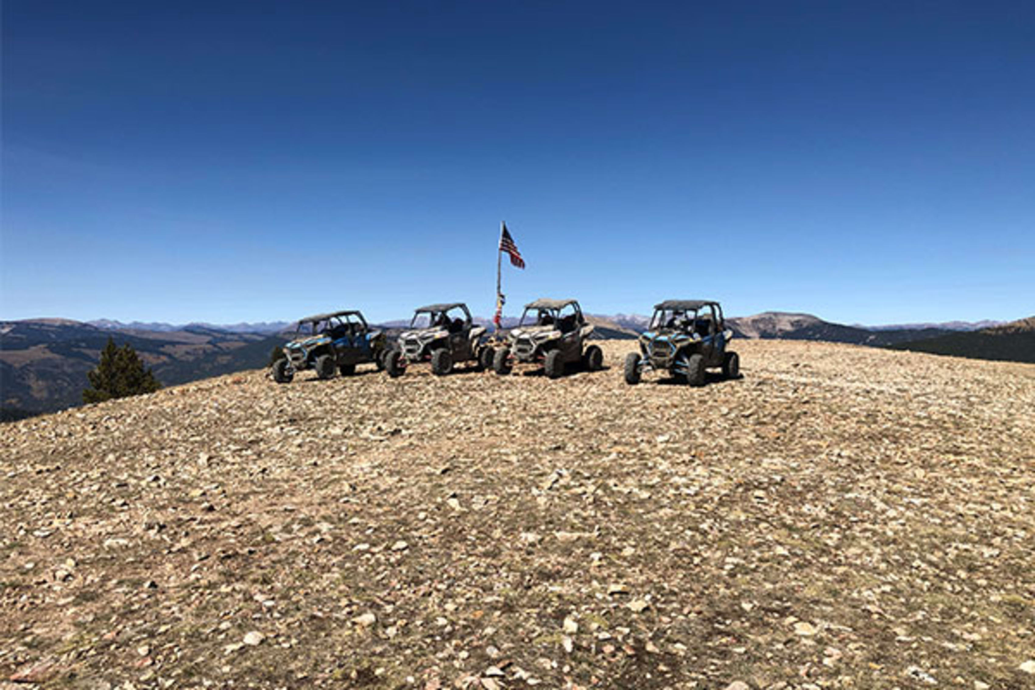 Four Polaris ATVs on top of Cross Mountain